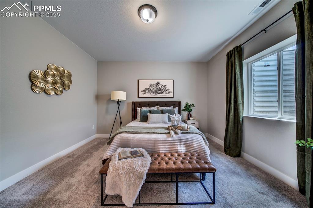Image 42 of 44: Carpeted bedroom with baseboards and visible vents