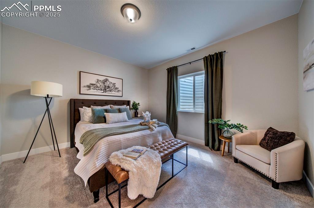 Image 43 of 44: Carpeted bedroom with baseboards