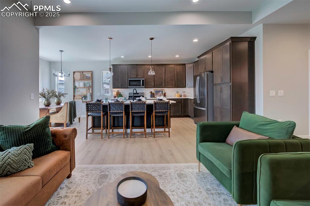 Image 7 of 44: Living room featuring recessed lighting and light wood-style flooring