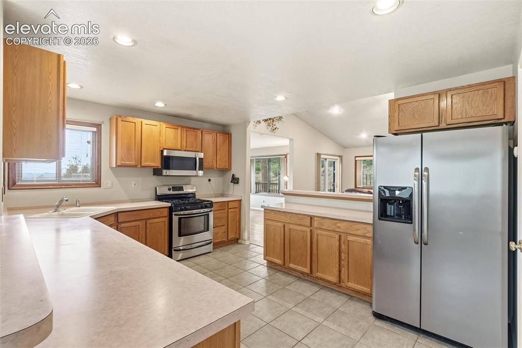 Image 11 of 29: Open kitchen layout overlooking the main living area, designed for comforta