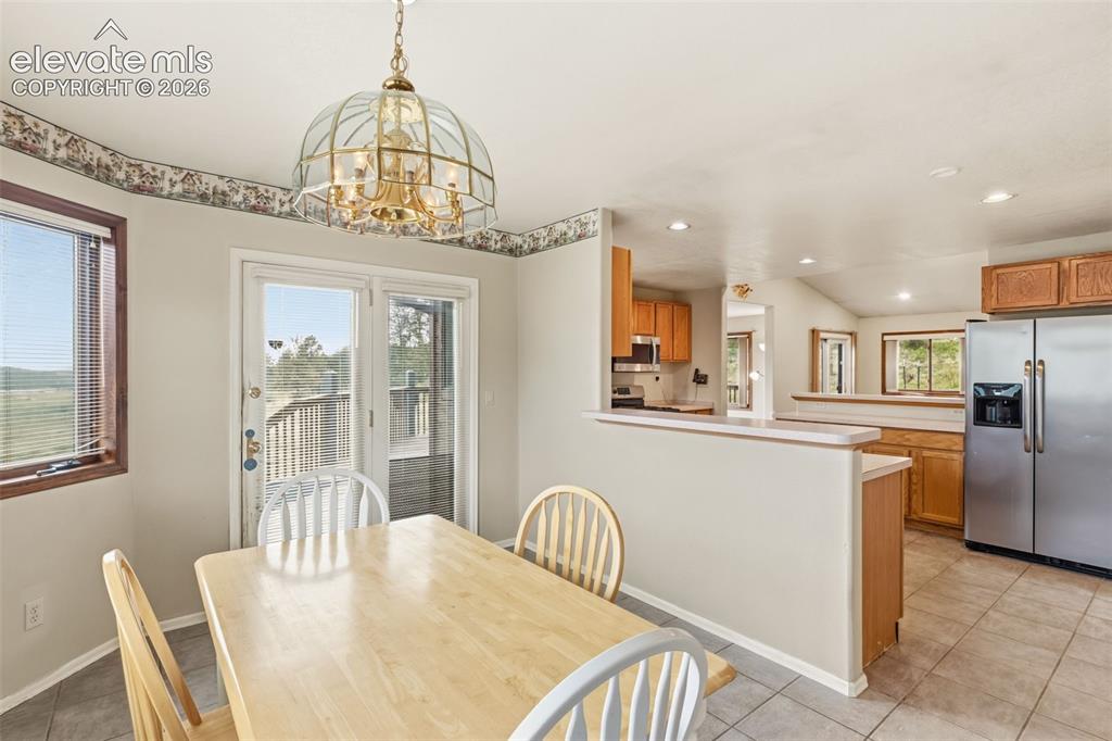 Image 13 of 29: Bright dining space flowing seamlessly into the kitchen and main living are