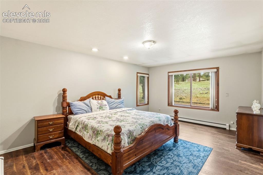Image 14 of 29: Spacious primary suite with oversized layout, large windows, and peaceful v