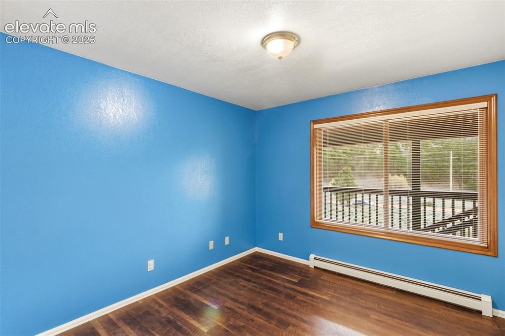 Image 19 of 29: Bright secondary bedroom featuring durable LVP flooring and large window br