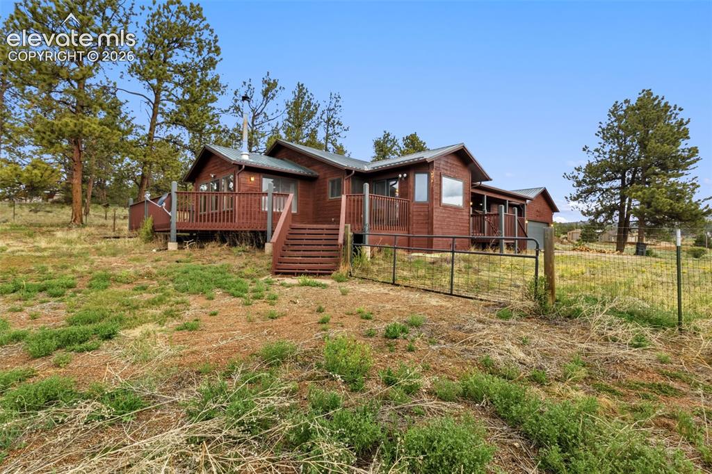 Image 2 of 29: Corner lot setting surrounded by Colorado mountain scenery with wraparound