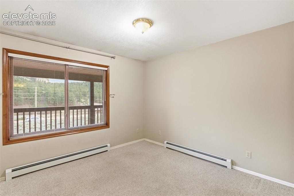 Image 20 of 29: Expanded secondary bedroom created by opening two original bedrooms into on