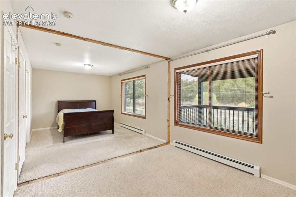 Image 21 of 29: Spacious multi use bedroom with large windows, natural light, and the flexi
