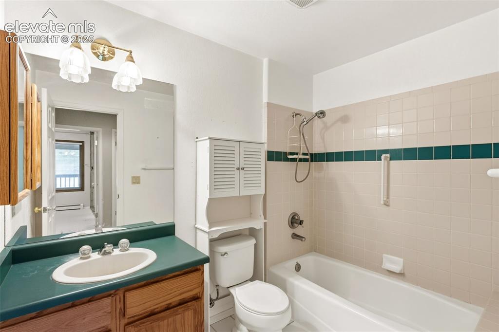 Image 22 of 29: Secondary full bathroom featuring a tub and shower combination and practica