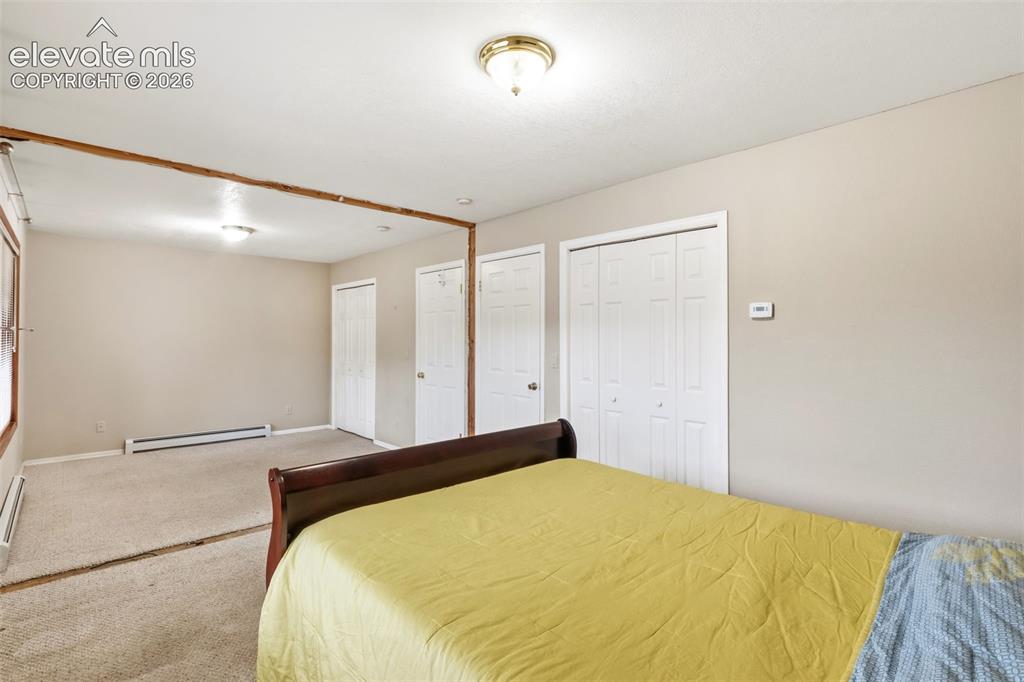 Image 24 of 29: Two original bedrooms have been opened into one oversized room, creating ad