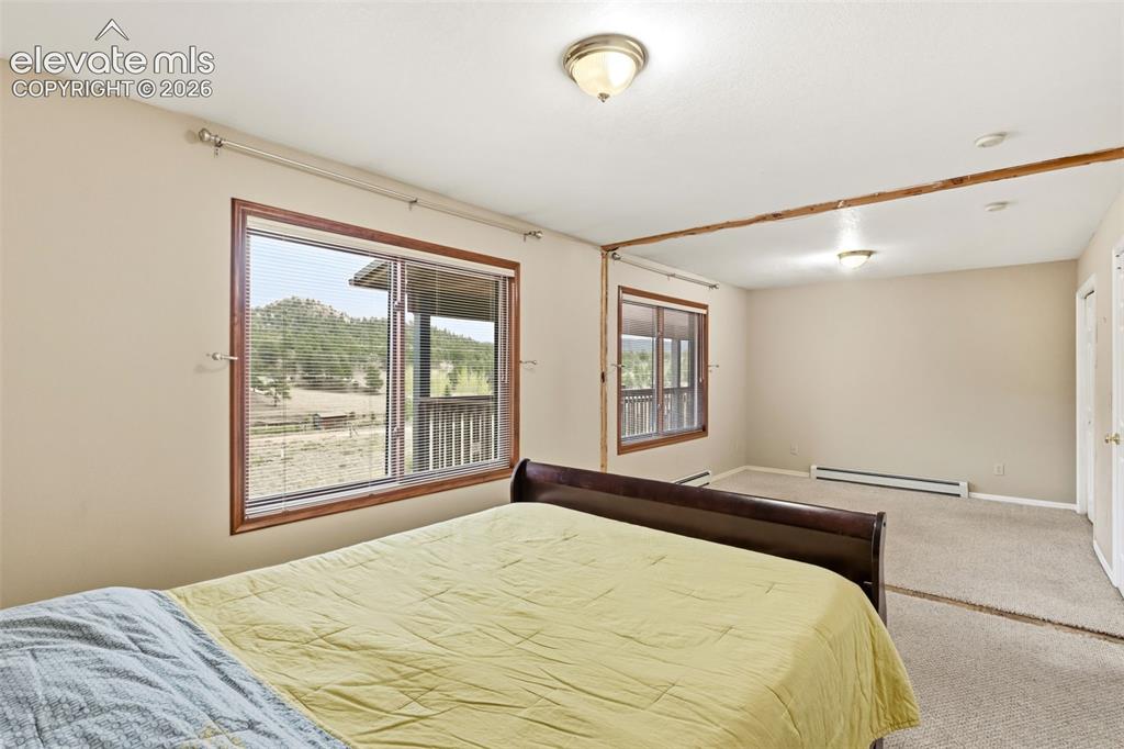 Image 25 of 29: Expanded bedroom configuration offering abundant space, natural light, and