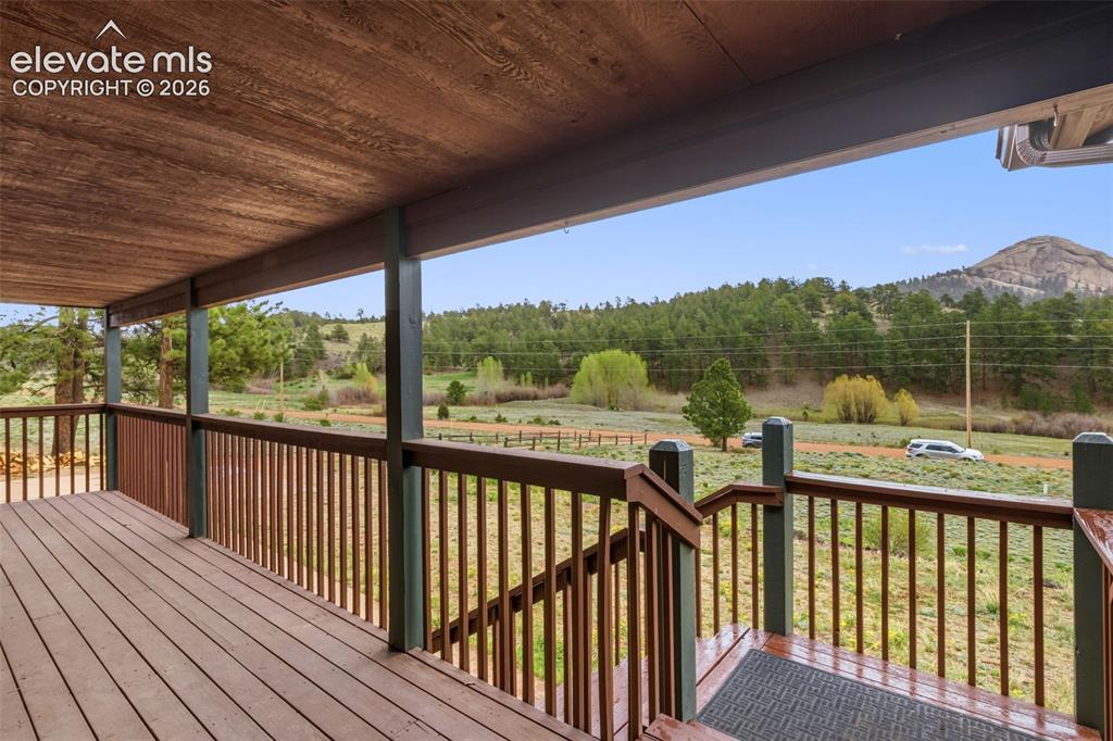Image 4 of 29: Covered deck overlooking open mountain scenery — the perfect place to enjoy