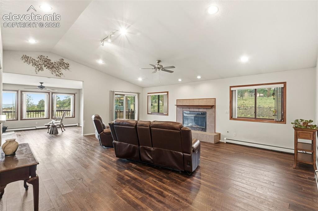 Image 5 of 29: Spacious open concept living room with vaulted ceilings, LVP flooring, rece
