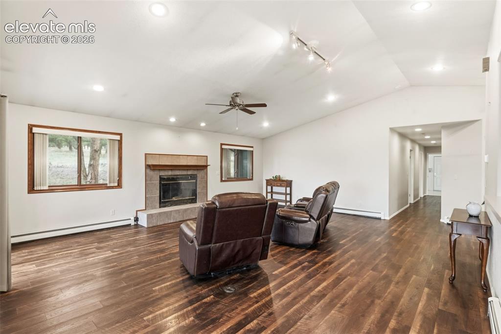 Image 7 of 29: Large gathering space featuring vaulted ceilings, gas fireplace, and flexib