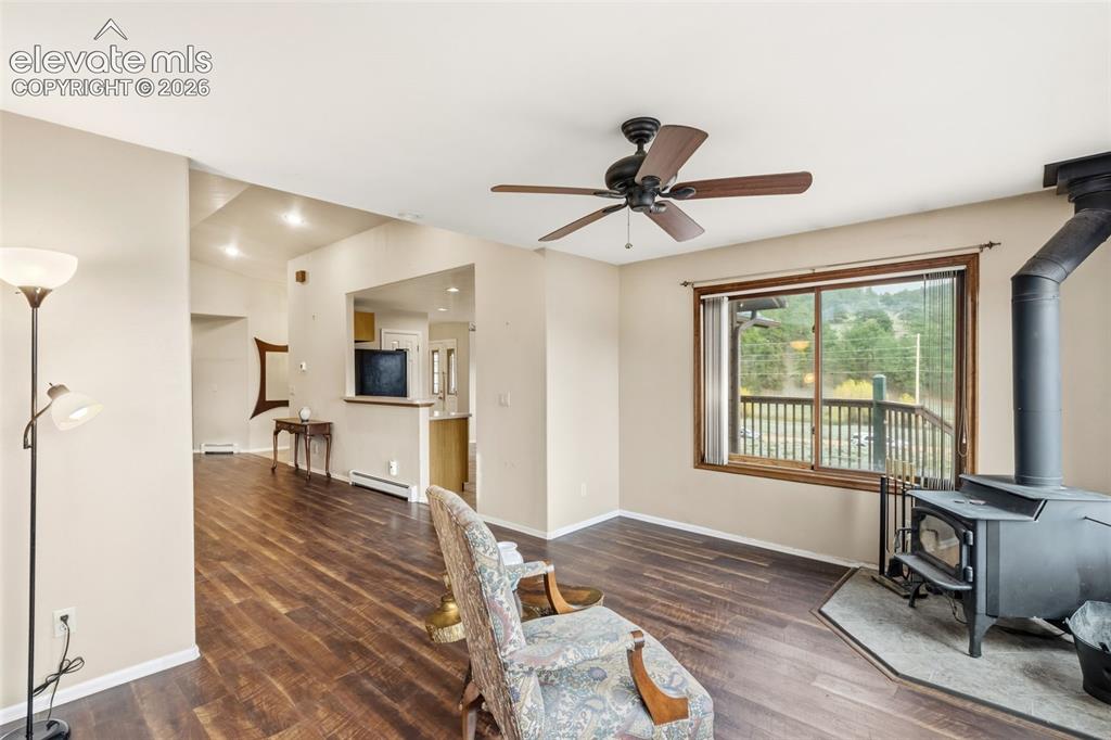 Image 9 of 29: Flexible office or sitting area featuring a woodburning stove, open connect