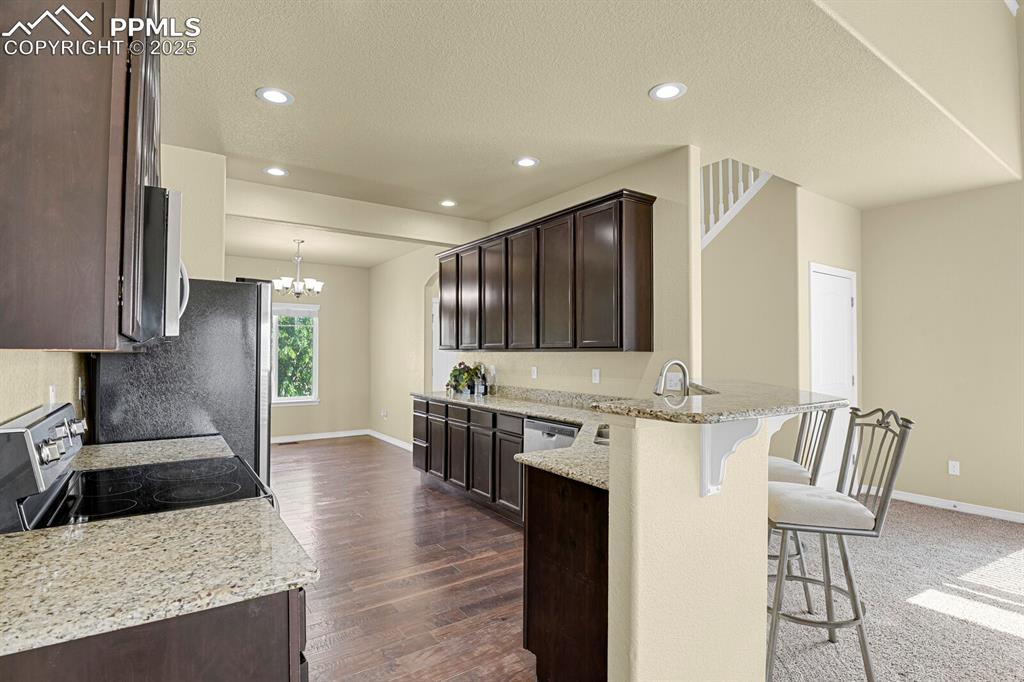 Image 10 of 33: Spacious kitchen with beautiful cabinets and granite countertops. 