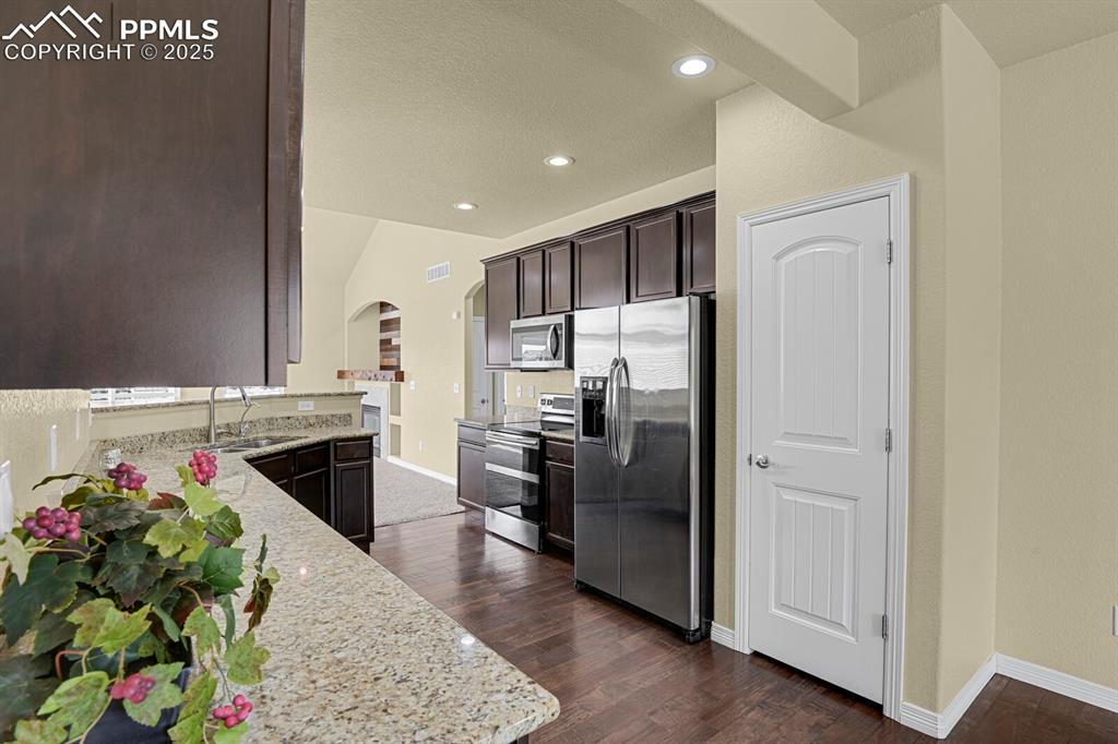 Image 12 of 33: Stainless less appliances and pantry. 