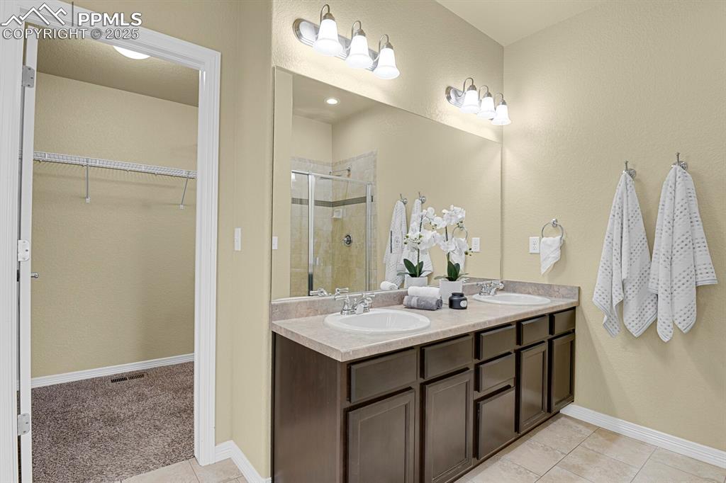 Image 20 of 33: Luxurious main level master bath with soaking tub, separate shower and walk