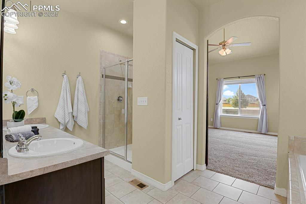 Image 21 of 33: Luxurious main level master bath with soaking tub, separate shower and walk