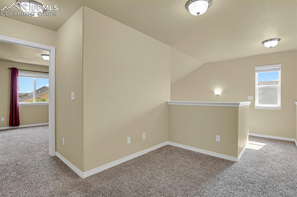 Image 25 of 33: Upper level loft ideal for a home office or play area. 