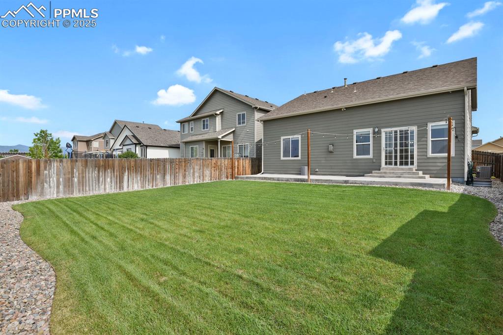 Image 31 of 33: Immaculate fully fenced back yard backing to open space with walking trails