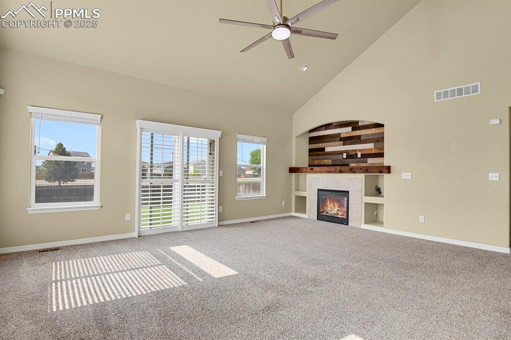 Image 7 of 33: Inviting, open living concept with vaulted ceiling and cozy fireplace. 