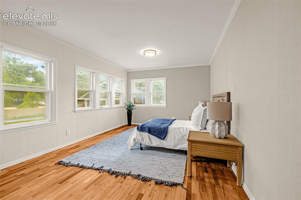 Image 32 of 50: Hardwood flooring throughout, multiple windows, and a flush mount ceiling l