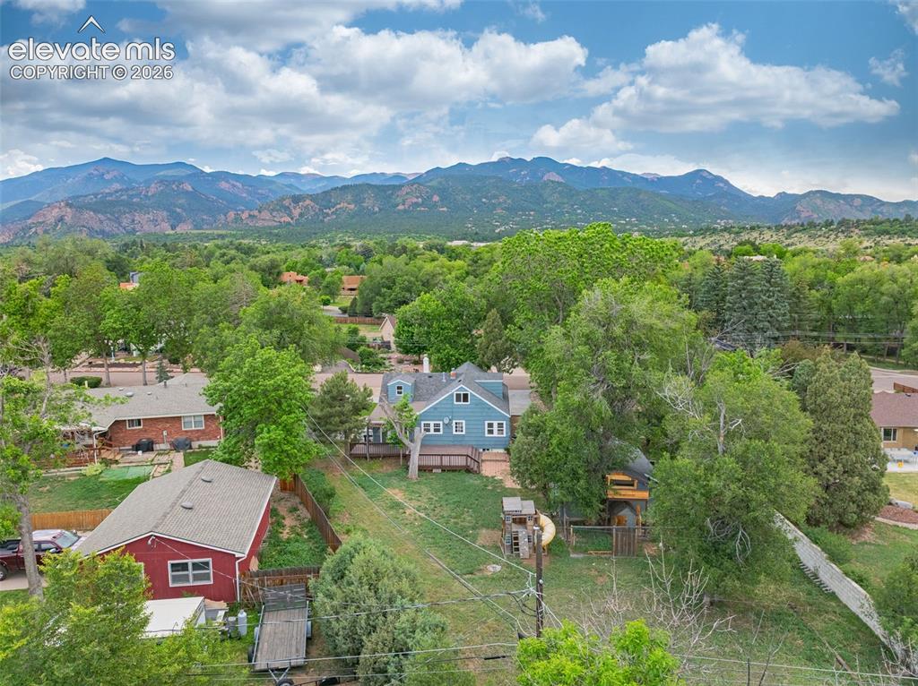 Image 40 of 50: Expansive mountain range backdrop, residential neighborhood setting, mature