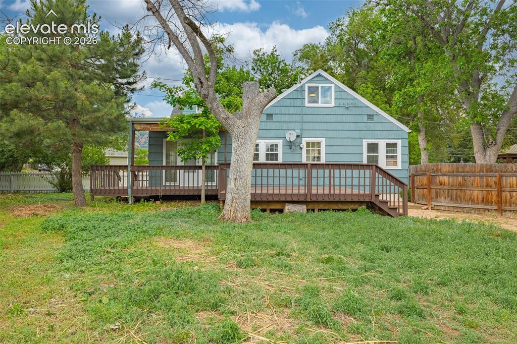 Image 44 of 50: Exterior featuring horizontal siding, an expansive wood-finish deck with ra