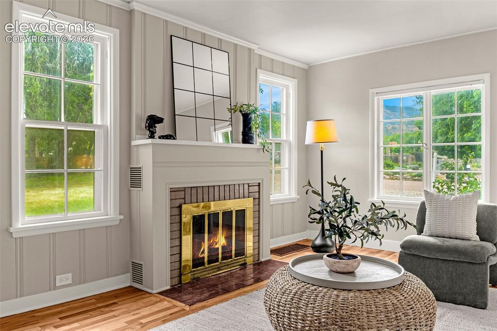 Image 7 of 50: Fireplace with brick surround and brass-finished doors
