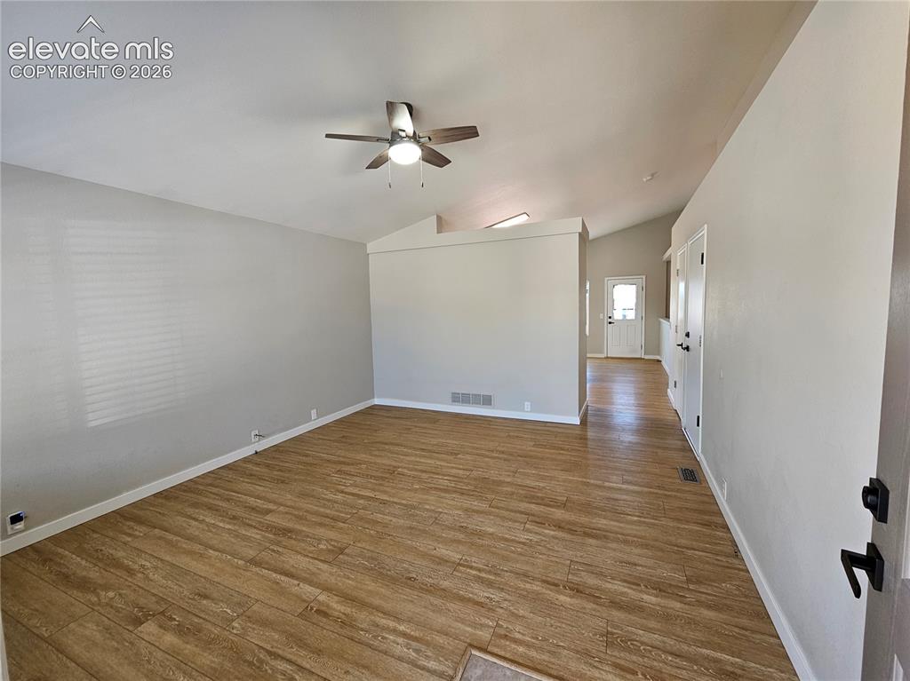 Image 3 of 26: Spacious interior featuring wood-finish flooring, vaulted ceilings, a ceili