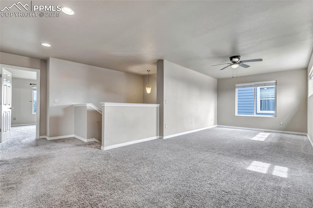 Image 17 of 50: Carpeted spare room featuring ceiling fan and recessed lighting