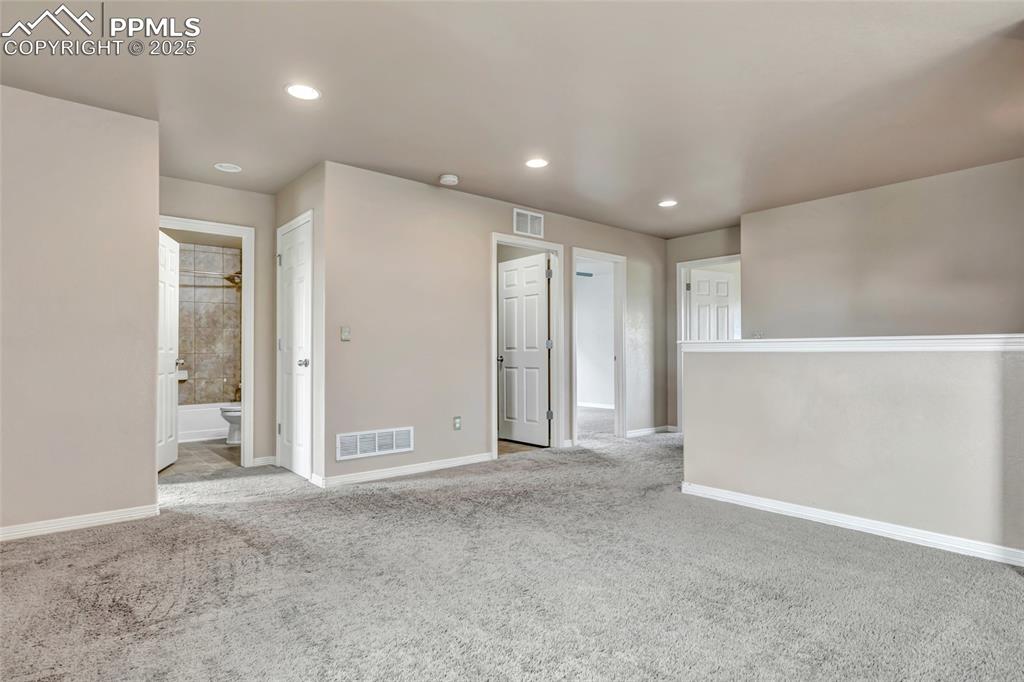 Image 19 of 50: Unfurnished room featuring light colored carpet and recessed lighting