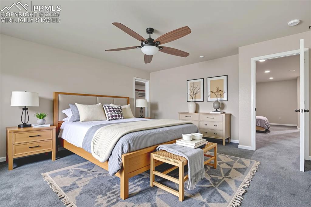 Image 25 of 50: Virtually Staged - Master Bedroom with carpet floors, a ceiling fan, and re
