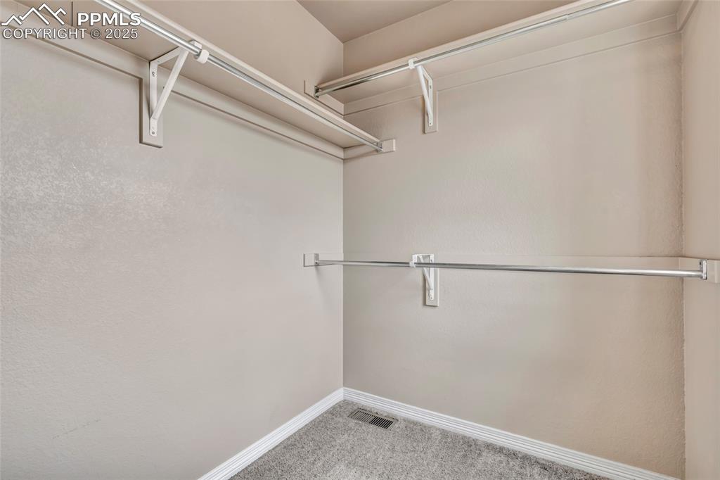 Image 34 of 50: Spacious closet with a window in Secondary bedroom 