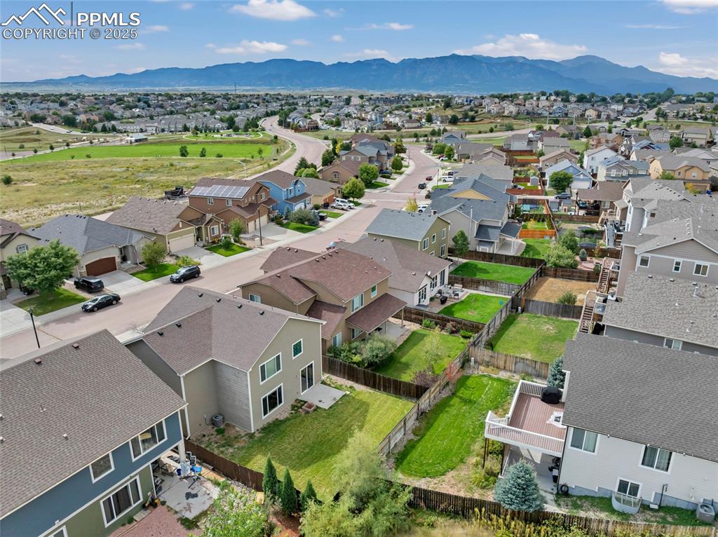 Image 41 of 50: Aerial perspective of suburban area with mountains