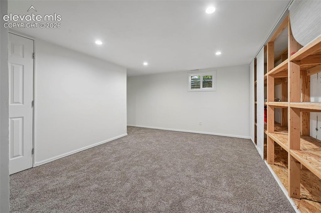 Image 22 of 27: Unstaged living room in basement