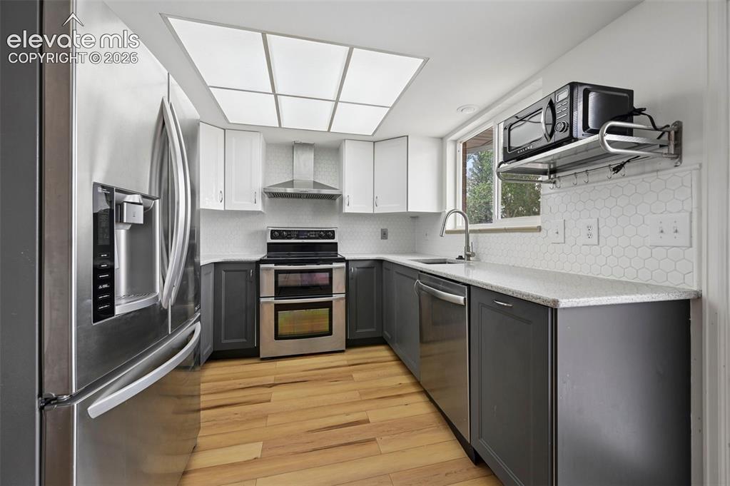 Image 7 of 27: Beautifully updated kitchen with stainless appliances
