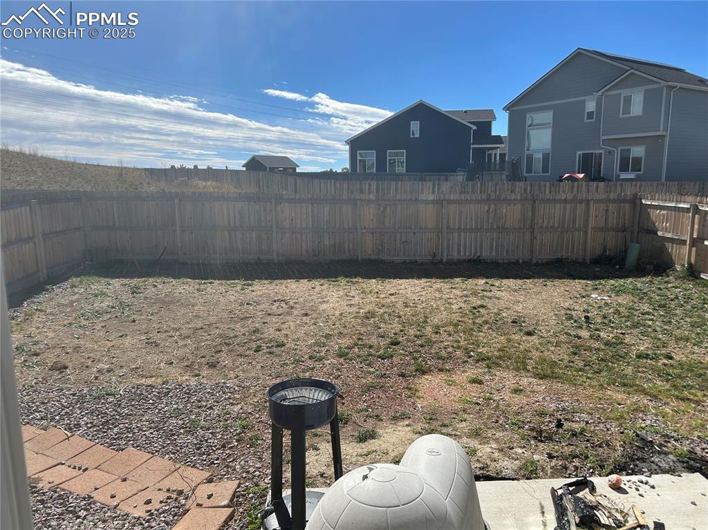 Image 3 of 8: View of fenced backyard