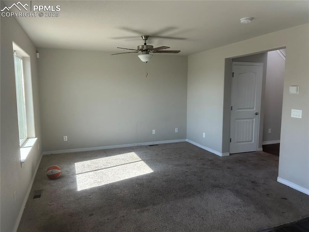 Image 4 of 8: Empty room featuring ceiling fan, carpet floors, and a smoke detector