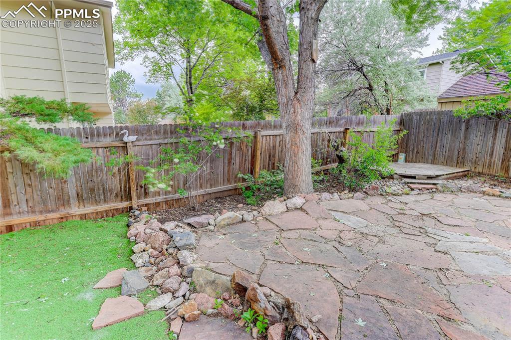Image 24 of 28: Flagstone area between turf & yard