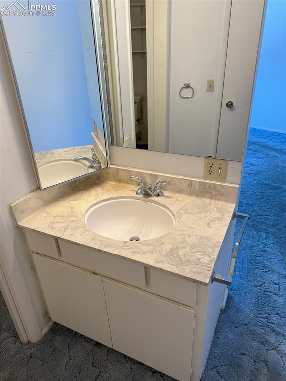 Image 12 of 33: One of two vanities in primary bath