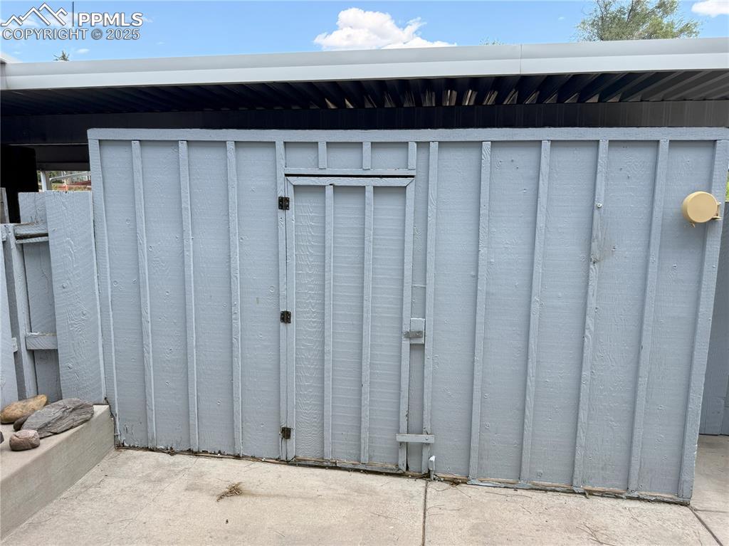 Image 28 of 33: Storage area attached to rear patio