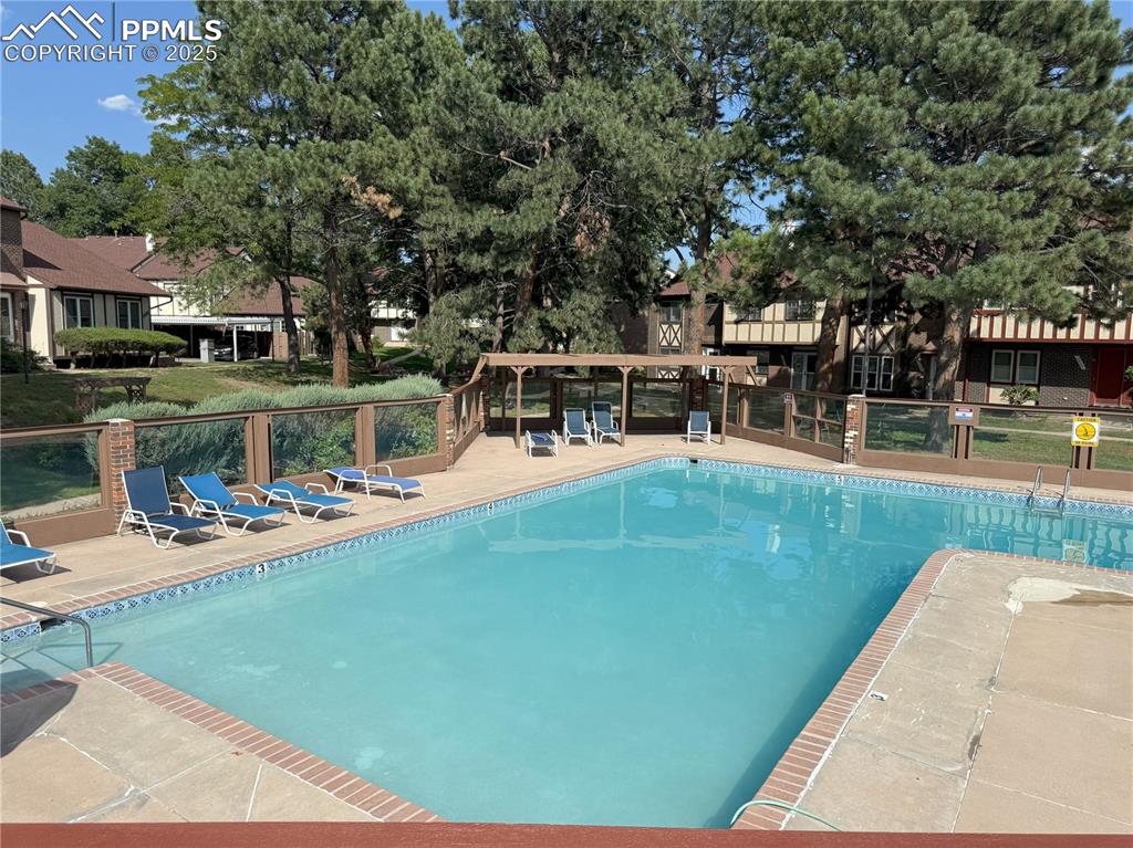 Image 31 of 33: Community pool featuring a patio area