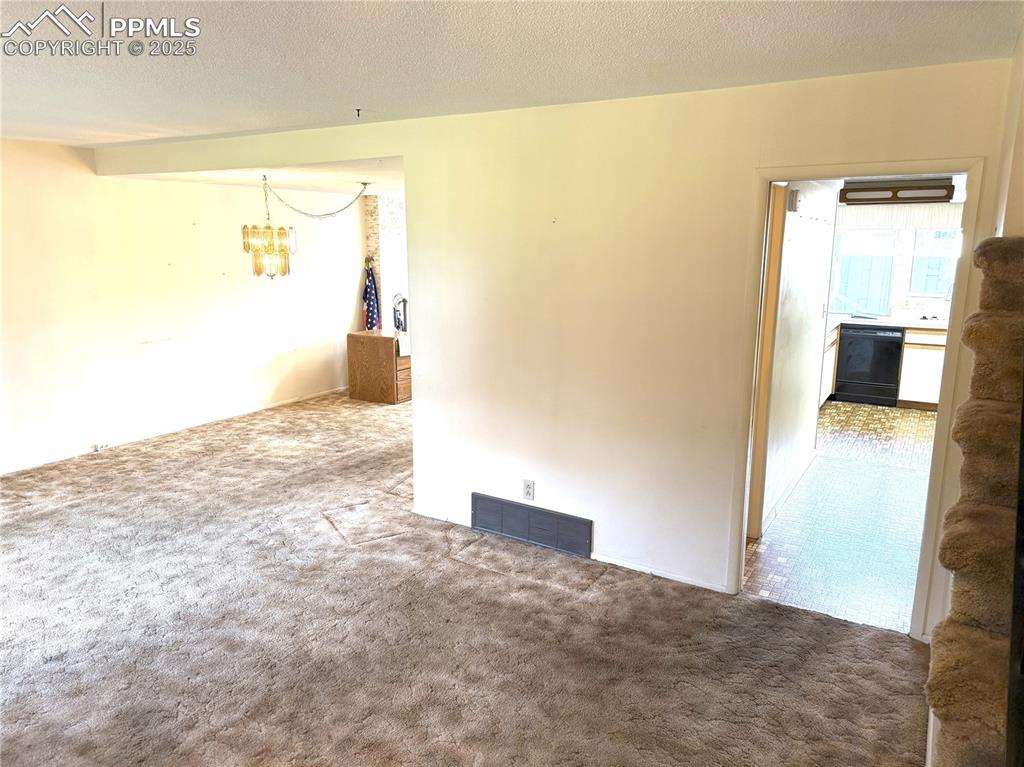 Image 9 of 33: View of living room and dining room from front entry