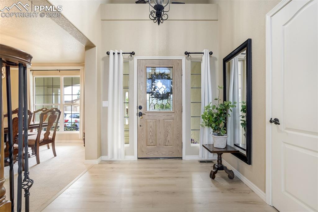 Image 17 of 50: Foyer featuring wood finished floors and baseboards