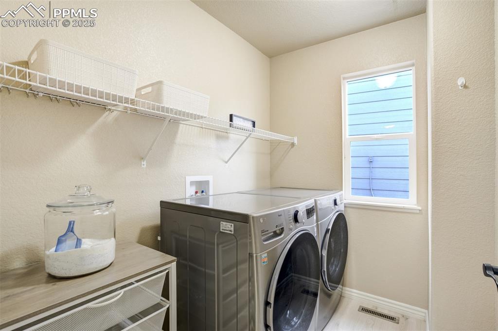 Image 20 of 50: Laundry area featuring washing machine and dryer and plenty of natural ligh