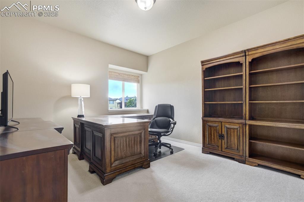 Image 29 of 50: Office space with light colored carpet and baseboards