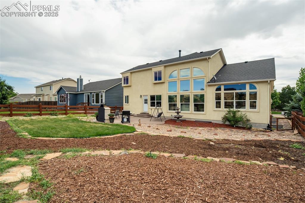 Image 47 of 50: Rear view of property with stucco siding, a patio, and entry steps