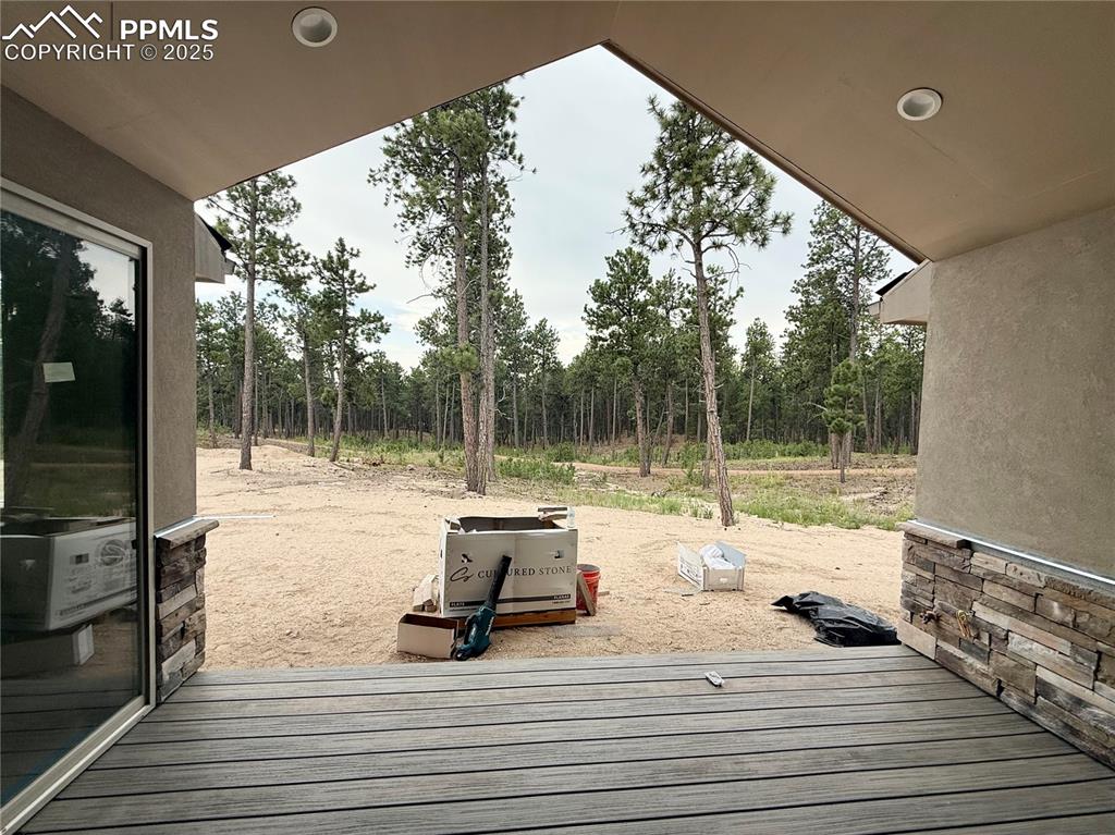 Image 14 of 18: Covered Deck With Forest View.