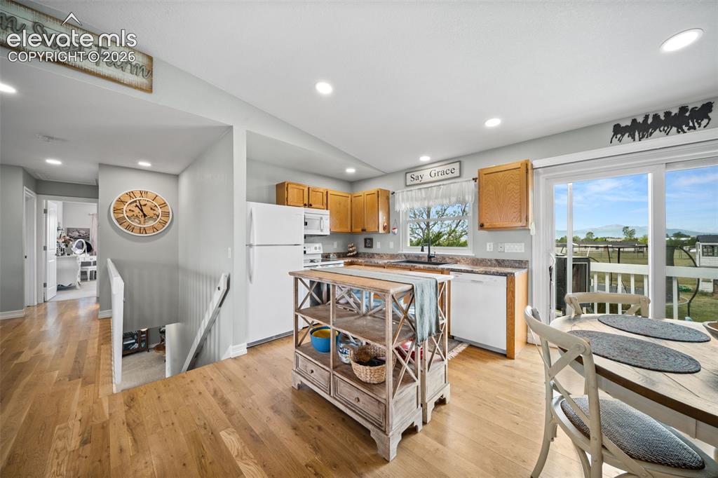 Image 14 of 50: Open-concept kitchen featuring wood-finish flooring, recessed lighting, woo