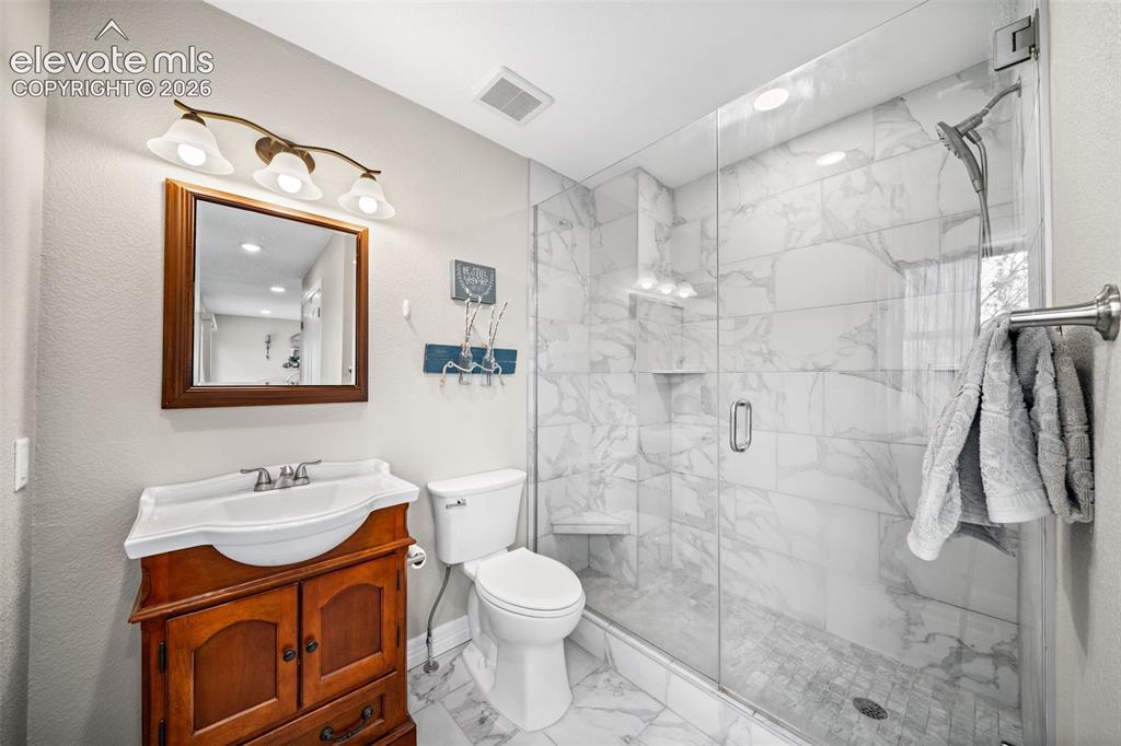 Image 22 of 50: Contemporary bathroom featuring a glass-enclosed shower with large format t